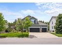 Traditional two-story home with a 3-car garage, nice lawn, and mature trees at 10802 W Indore Dr, Littleton, CO 80127