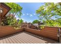 Exterior view of a private deck surrounded by mature trees offering privacy and an outdoor space for relaxation at 9400 E Iliff Ave # 88, Denver, CO 80231
