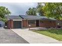 Lovely single story brick home with a driveway and front yard at 6176 Ammons St, Arvada, CO 80004