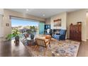 Cozy living room with a fireplace, stylish furniture, and sliding glass doors to the balcony at 17860 Calendula Dr, Parker, CO 80134