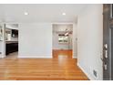 Bright living room showcasing hardwood floors and seamless flow to dining area and kitchen at 4780 E Montana Pl, Denver, CO 80222