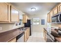 Functional kitchen with wood cabinets, laminate countertops, and modern stainless steel appliances at 1737 Beeler St, Aurora, CO 80010