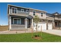 Beautiful two-story home boasts a cozy front porch and an attached three-car garage at 4113 Marble Dr, Mead, CO 80504