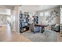 Comfortable office with stylish built-in shelving, a desk, a rug, and decor at 4113 Marble Dr, Mead, CO 80504