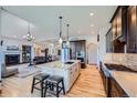 Beautiful kitchen with an island, updated appliances, and an open layout to the living area at 4781 Mariposa Rd, Castle Rock, CO 80104