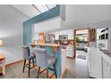 Charming kitchen with barstool seating, white cabinets, and an open view to the living room at 5323 E Sandpiper Ave, Castle Rock, CO 80104