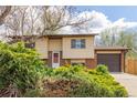 Inviting home featuring a well-manicured lawn, mature bushes, and a two-car garage for ample parking at 778 2Nd St, Firestone, CO 80520