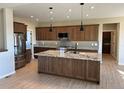 Spacious kitchen featuring granite countertops and modern wood cabinets at 39110 E 146Th Ct, Keenesburg, CO 80643