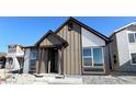 Inviting single-Gathering home with well-maintained landscaping, a covered porch, and contemporary architectural elements at 2277 Serenidad St, Brighton, CO 80601