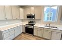 Modern kitchen featuring stainless steel appliances, white cabinetry, and complementary countertops at 2277 Serenidad St, Brighton, CO 80601