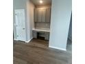 Home office nook featuring built-in cabinets, a desk area, and neutral paint at 2277 Serenidad St, Brighton, CO 80601