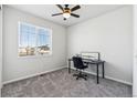 Bright bedroom with a ceiling fan, a work desk, and a window at 5670 Pinto Valley St, Parker, CO 80134