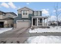 Two-story house with gray siding, white trim, and a covered porch at 3260 Jonquil St, Castle Rock, CO 80109