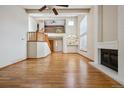 Bright, open living room with hardwood floors, fireplace, and soaring ceilings at 8563 Redstone St, Highlands Ranch, CO 80126