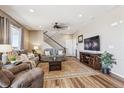 Comfortable living room featuring hardwood floors, a ceiling fan, and neutral paint at 27319 E 10Th Dr, Aurora, CO 80018