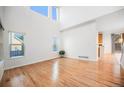 Bright living room featuring hardwood floors, large windows, and ample natural light at 5607 S Gray St, Littleton, CO 80123