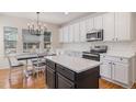 Eat-in kitchen with center island and stainless steel appliances at 11973 Song Bird Hills St, Parker, CO 80138