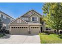 Charming two-story home features a three-car garage, stone accents, and a well-maintained lawn at 11973 Song Bird Hills St, Parker, CO 80138