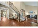 Inviting foyer with a staircase, hardwood floors, and elegant decor at 15756 E Aberdeen Ave, Centennial, CO 80016