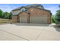 Spacious three-car garage with ample parking and a large driveway at 15756 E Aberdeen Ave, Centennial, CO 80016
