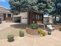 Charming brick home with an attached one-car garage and well-maintained landscaping at 7079 Estes Dr, Arvada, CO 80004