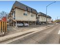 Apartment complex with ample parking and vintage architecture, featuring elevated units and brick facade at 1265 Colorado Blvd # 7, Denver, CO 80206