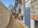 Apartment complex exterior showing access way to a unit with stone foundation and elevated entry at 1265 Colorado Blvd # 7, Denver, CO 80206