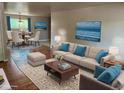 Stylishly furnished living room features hardwood floors, a plush sofa, and serene artwork for an inviting space at 6085 Simms St, Arvada, CO 80004