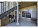 Private patio with grill, table, and stairs at 5800 Tower Rd # 103, Denver, CO 80249