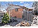 Charming brick home with well-maintained exterior and fenced yard at 4940 W 9Th Ave, Denver, CO 80204