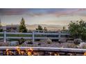 Relax and unwind in this backyard with stunning mountain views, a charming fence, and a cozy fire pit at 10698 Mountaingate Ct, Littleton, CO 80126