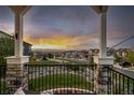 Enjoy breathtaking sunset views from this relaxing balcony complete with stone pillars and iron railings at 10698 Mountaingate Ct, Littleton, CO 80126