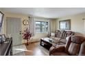 Living room with entryway and large windows, offering ample natural light at 8377 Mitze Dr, Denver, CO 80221