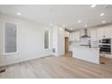 Open-concept living and kitchen area with recessed lighting and modern finishes at 1243 Rhett Dr, Erie, CO 80026