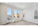 Bright living space features a door to a balcony with great neighborhood views at 1243 Rhett Dr, Erie, CO 80026