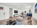 Bright living room with hardwood floors, open to dining and kitchen with an open floor plan at 3640 Forest St, Denver, CO 80207