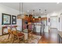 Open concept dining and kitchen area with stainless steel appliances and granite countertops at 6948 W Jewell Dr, Lakewood, CO 80227