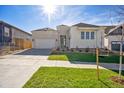Charming single-Gathering home with white brick and siding, a well-manicured lawn, and a two-car garage at 17054 Hop Clover Ave, Parker, CO 80134