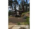View of exterior elevation of cabin-style home with stairs leading to a deck at 27447 Upper Cold Spg Gulch Rd, Golden, CO 80401
