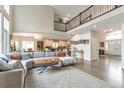Open-concept living room provides ample space and natural light, seamlessly connecting to kitchen and dining areas at 10773 Cougar Rdg, Lone Tree, CO 80124