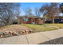 Attractive brick home with lush lawn, rock wall, and sidewalk appeal at 1632 Ulster St, Denver, CO 80220