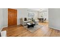 Bright living room featuring hardwood floors, neutral sofa, and ample natural light at 1632 Ulster St, Denver, CO 80220