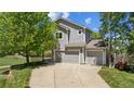 Charming two-story home with a three-car garage and mature landscaping on a sunny day at 10570 Echo Ct, Firestone, CO 80504