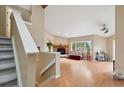 Bright living room with hardwood floors, fireplace, and a large window for natural light at 3390 S Ensenada Way, Aurora, CO 80013