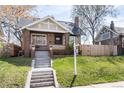 Charming brick bungalow with inviting front porch and well-manicured lawn at 4244 Grove St, Denver, CO 80211