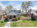 Charming brick bungalow with inviting front porch, lovely yard, and mature trees at 4244 Grove St, Denver, CO 80211