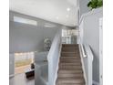 Carpeted stairway leading up to a split level with a glimpse of the kitchen at 4599 Argonne St, Denver, CO 80249