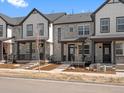 Charming townhouse showcasing stone facade, inviting porch and manicured front yard, perfect for relaxed living at 742 N Tempe St, Aurora, CO 80018
