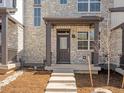 Inviting front porch with stone accents, providing a welcoming entrance to the home's exterior at 742 N Tempe St, Aurora, CO 80018