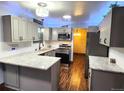 Updated kitchen with granite countertops, stainless appliances and blue accent lighting at 3216 S Granby Way, Aurora, CO 80014